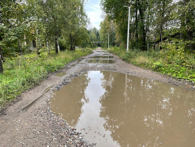 Huge puddles on country road Water obstacles on road in countryside