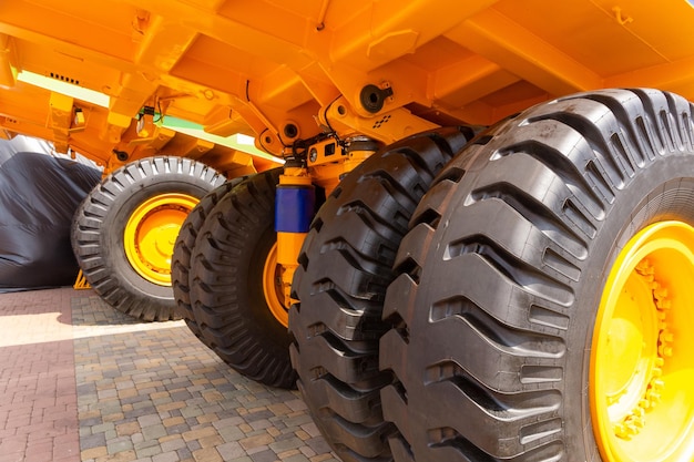 Huge rear wheels of dump truck at unusual angle closeup