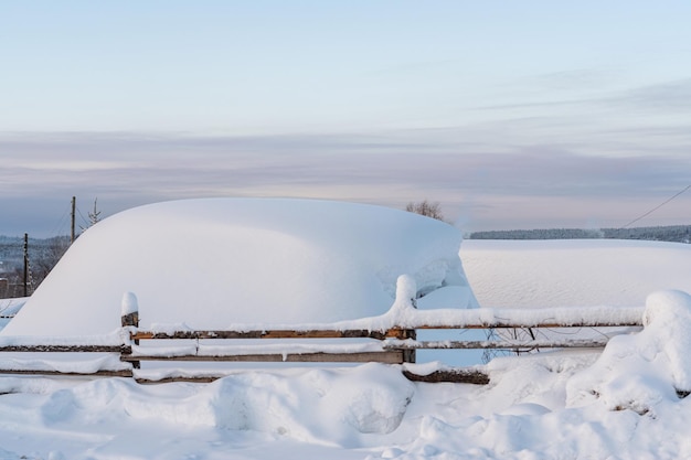 Huge snowdrift in the village, winter scene in Russia, Perm krai