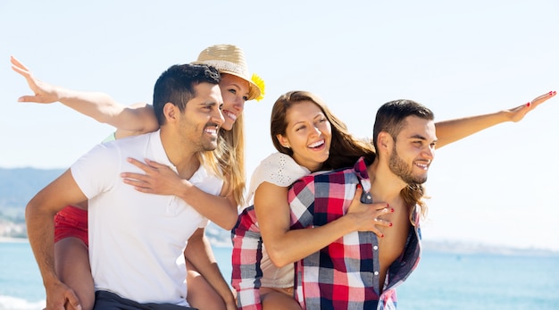 hugging couples on beach