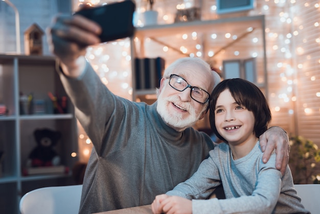 Hugging Grandfather and Grandson Making Selfie