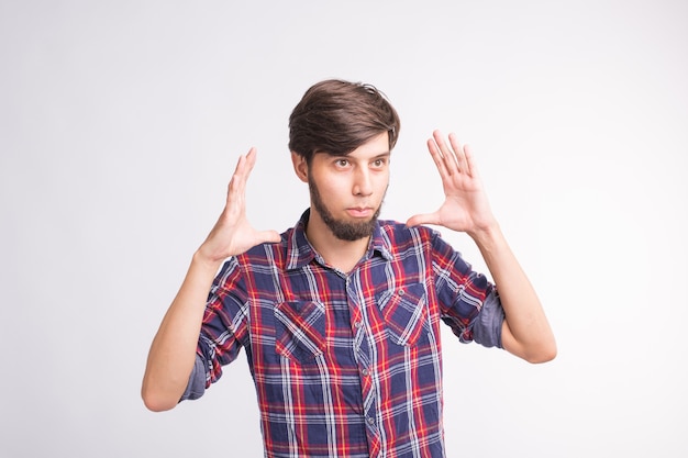 Human emotion, facial expression concept - bearded man holding two hands in front of him and shows