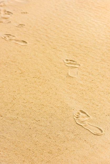 Photo human footprints on the sand