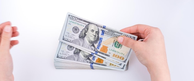 Human hand holding American dollar banknotes on white background