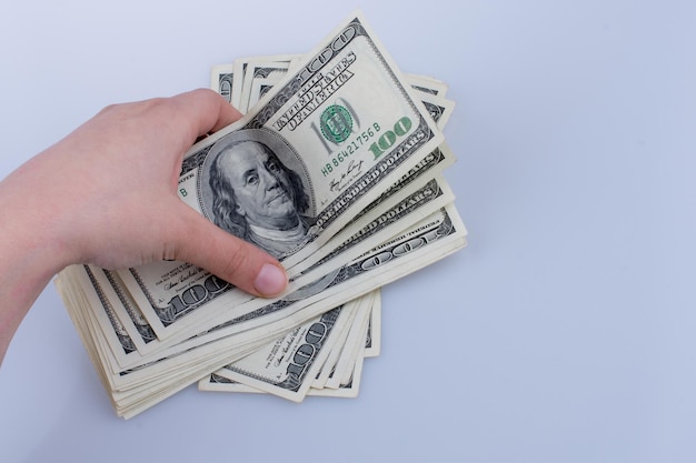 Human hand holding American dollar bill as money isolated on white