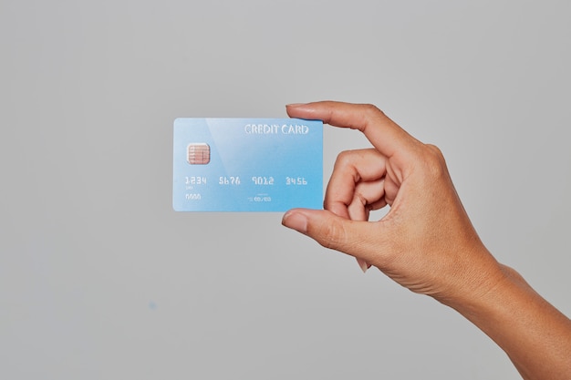 Human hand holding bank credit card