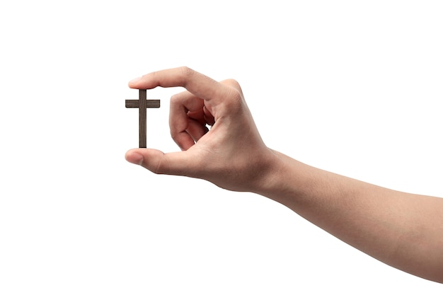 Human hand holding Christian cross isolated over white background