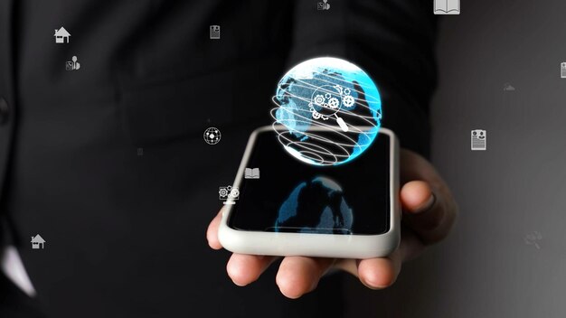 Human hand holding mobile phone with earth globe holographic technology