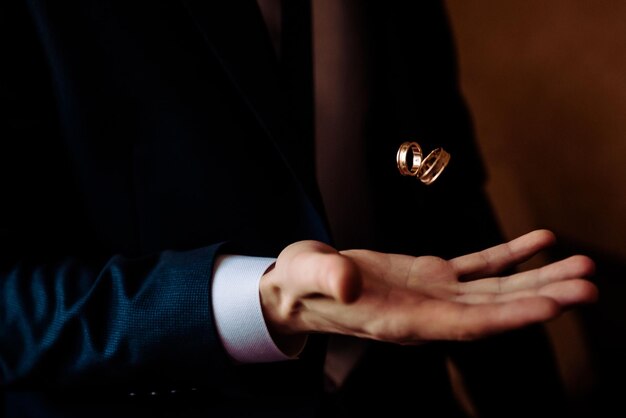 Photo human hand holding a ring inside on white background