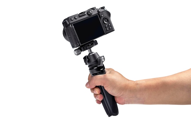 Human hand holding tripod with camera