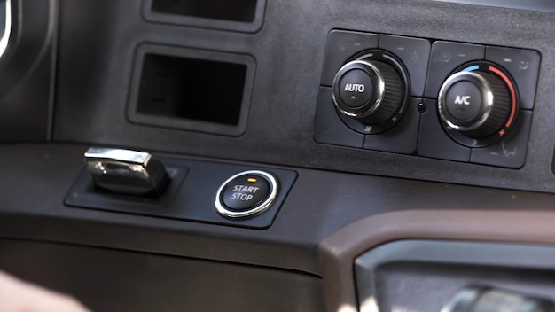 Human hand putting the put start and stop button in the sport luxury car