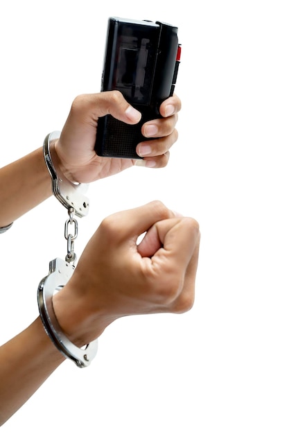 A human hand with a handcuff holding a recording device