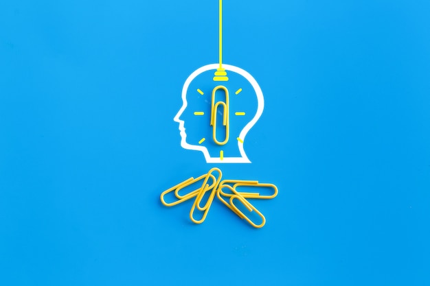 human head and paperclip connected together