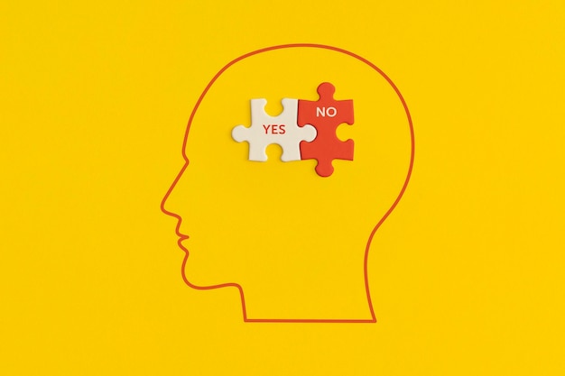 Human head with puzzle on yellow background