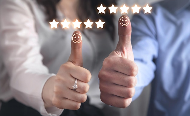 Photo human making thumb up with a happy smiley face and five star