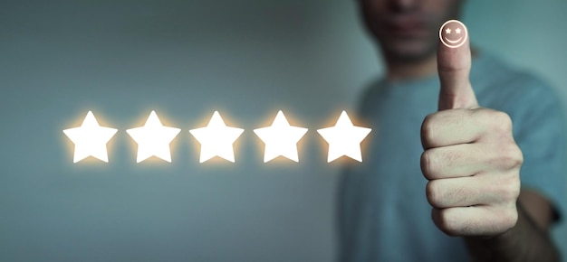 Human making thumb up with a happy smiley face and five star