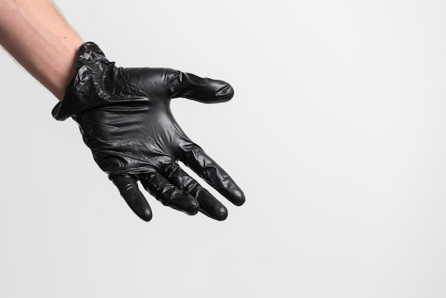 A human palm wearing black latex glove isolated