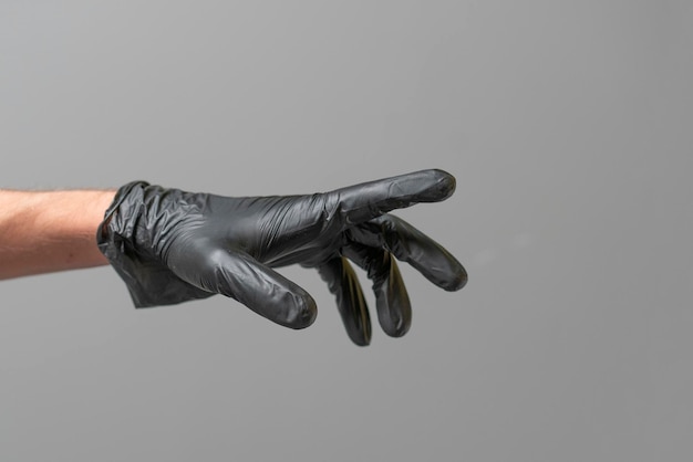 A human palm wearing black latex glove isolated