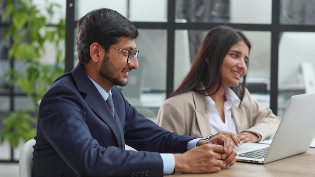 Human resources team sitting in a row at table in office