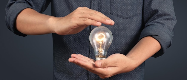 Humans hold light bulbs in hand innovative technology and creativity