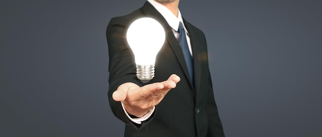 Humans hold light bulbs in hand innovative technology