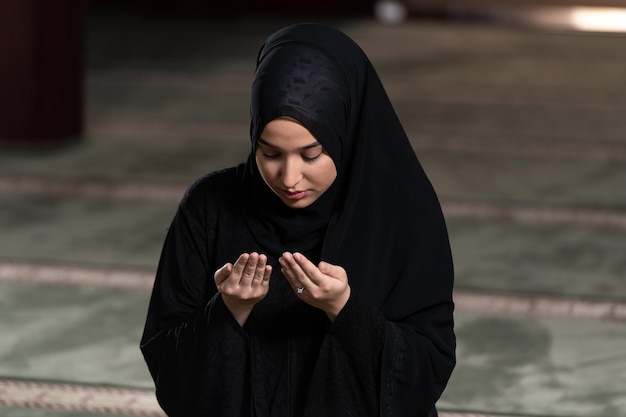 Humble Muslim Woman is Praying in the Mosque