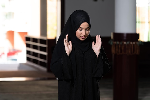 Humble Muslim Woman is Praying in the Mosque