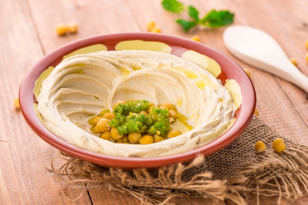 Hummus plate served in dish isolated on table side view of arabic food