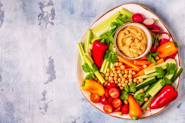 Hummus with various fresh raw vegetables.