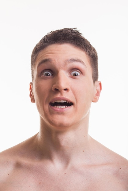 Humorous emotional portrait of grimacing young man