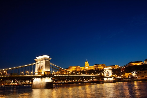 Hungarian landmarks at nighttime Chain bridge over the Danube river Hungary