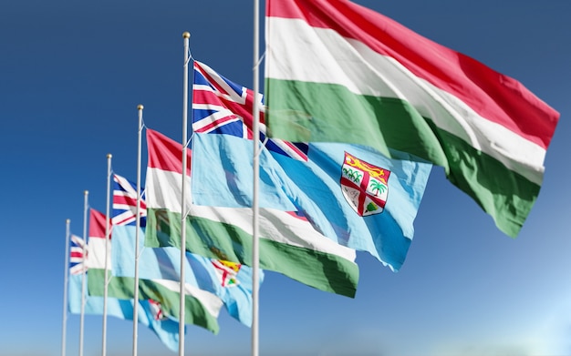 Hungary Fiji flags waving at sky background