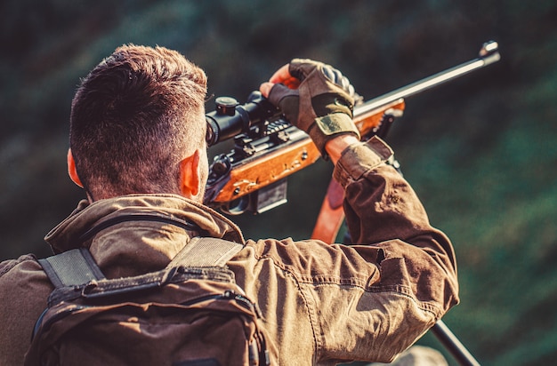 Hunting period. Male with a gun. Close up. Hunter hunting gun