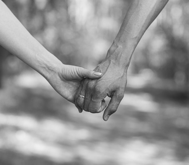 The husband39s flour holds his wife39s hand tightly in closeup