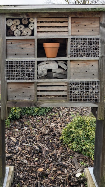 Hut bug hotel insect house wooden give protection and nesting aid to bees and insects outdoor