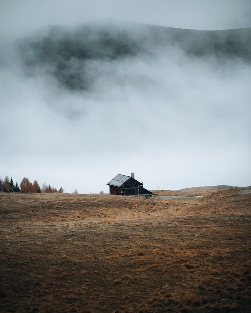 Hut by the curve road on a foggy hill