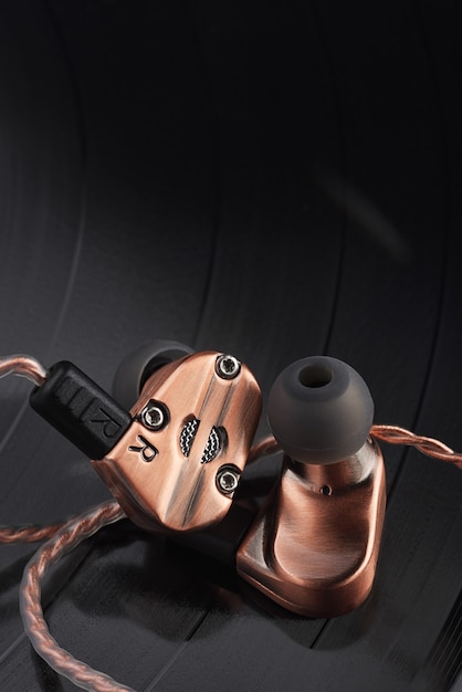 Hybrid dynamic driver balanced armature ear-buds on the LP vinyl record.