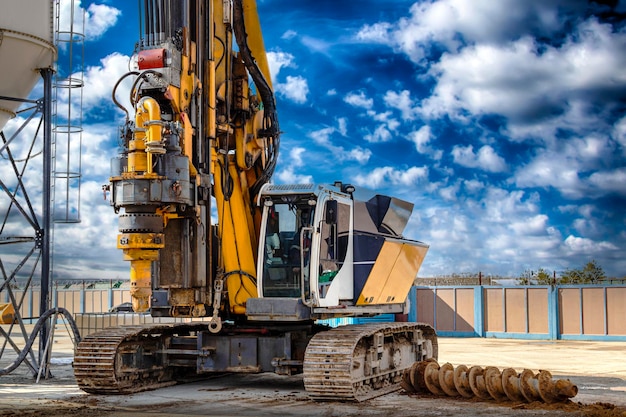 Hydraulic drilling rig against the blue cloudy sky Installation of bored piles by drilling Foundations and foundations Drilling in the ground