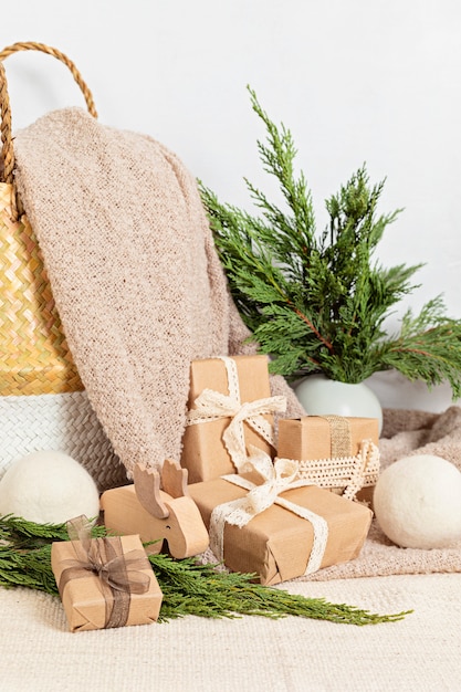 Hygge eco friendly paper wrapped presents with basket and warm soft blanket. Scandinavian Christmas zero waste decorations and gifts