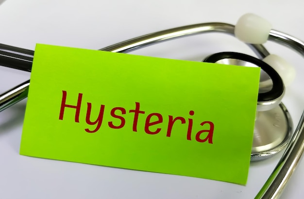 Hysteria medical term word in green card on white background with stethoscope.