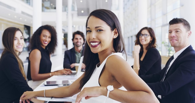 I always enjoy these meetings Cropped shot of a young businesswoman smiling in an office during a meeting with her colleagues in the background