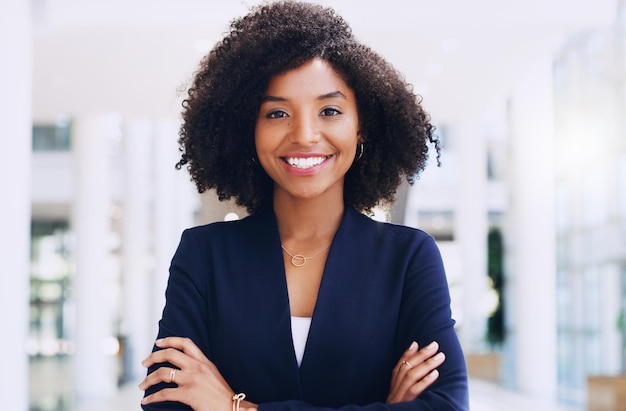 I am proud of how far I have come Cropped portrait of an attractive young businesswoman smiling and standing in the office with her arms crossed during the day