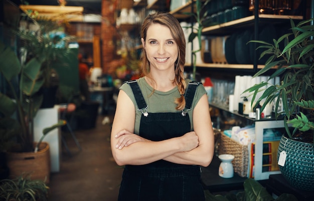 I am proud of myself Cropped portrait of an attractive young business owner standing in her floristry alone with her arms folded