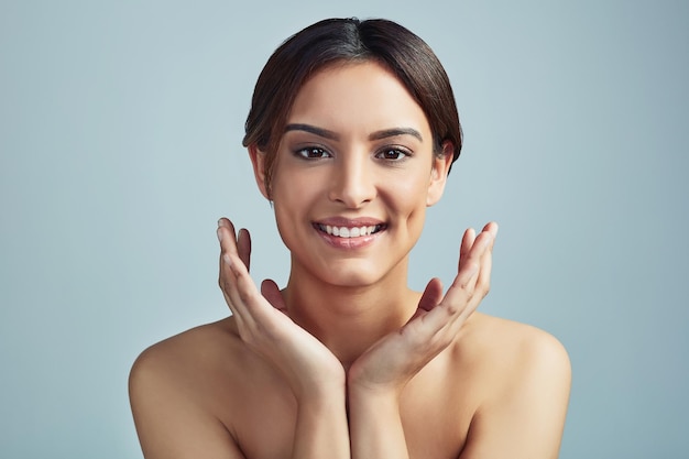 I couldnt be happier with my skincare regimen Studio portrait of a beautiful young woman with flawless skin against a grey background