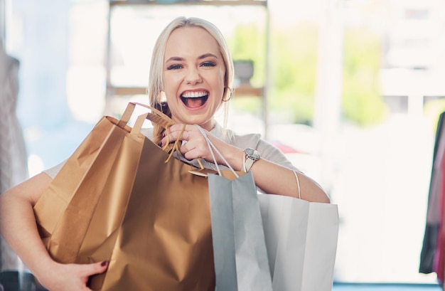 Photo i got them all on sale shot of an attractive young woman carrying shopping bags