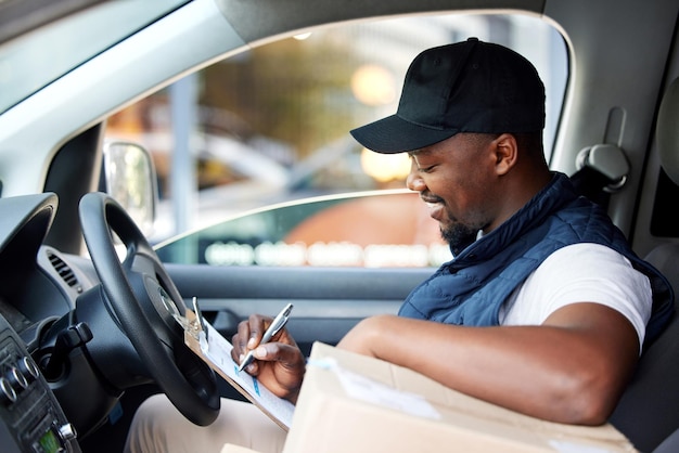 I have one more delivery to do for the day Shot of young man delivering a package while sitting in a vehicle