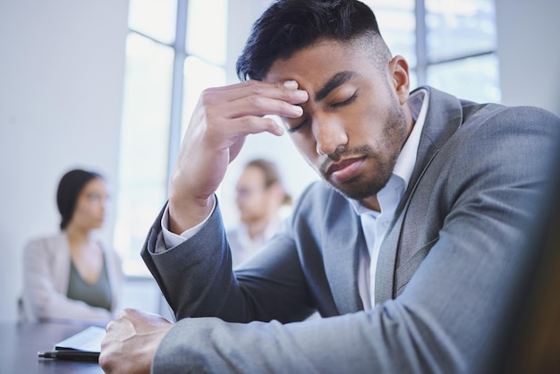 I hope I dont get asked about it Shot of a young businessman looking stressed while sitting in a meeting