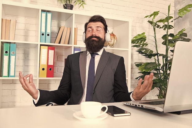 I love meditation Businessman sit with mudra gesture Music for meditation Bearded man enjoy meditation in office Meditation and concentration Zen and enlightenment Listen to yourself