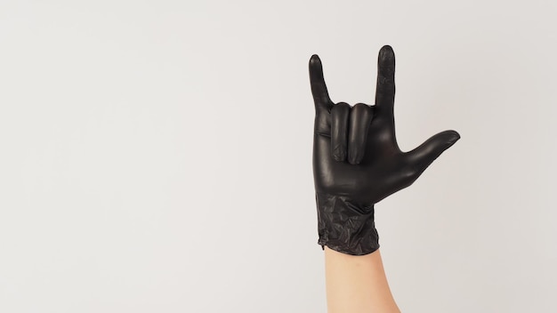 I love you hand sign and hand wear black latex glove on white background