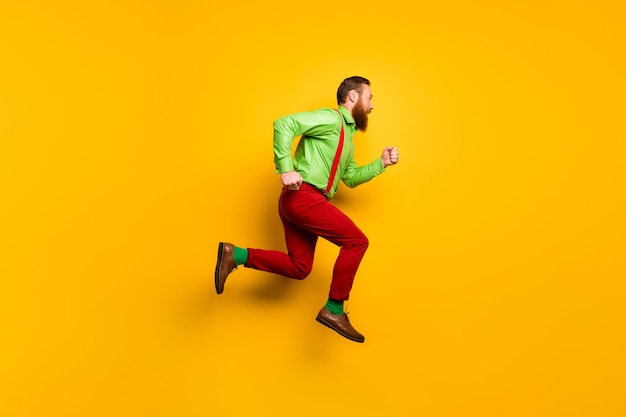 I need run faster! Full length profile side photo of focused irish gentleman jump hurry want buy shopping center discount wear good look outfit isolated over yellow color